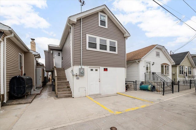 view of front of house featuring uncovered parking and heating fuel