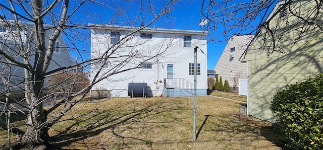 rear view of property featuring a lawn