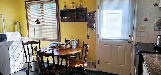 dining space with washer / clothes dryer and plenty of natural light