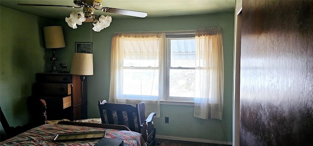 bedroom with ceiling fan and baseboards