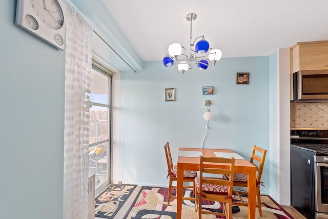 dining space featuring baseboards and a notable chandelier