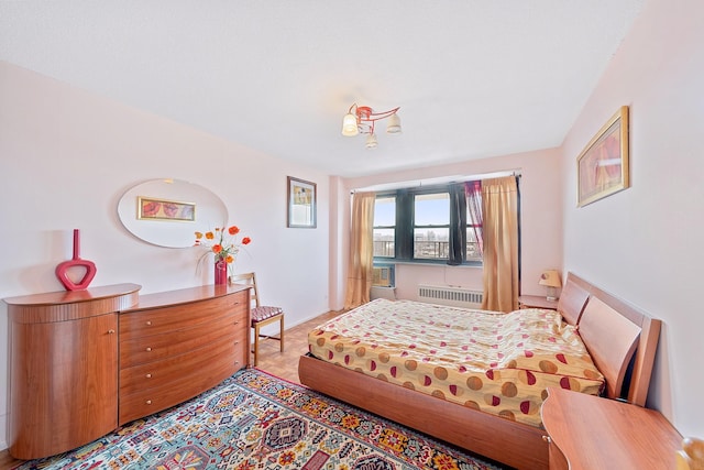 bedroom featuring radiator and baseboards