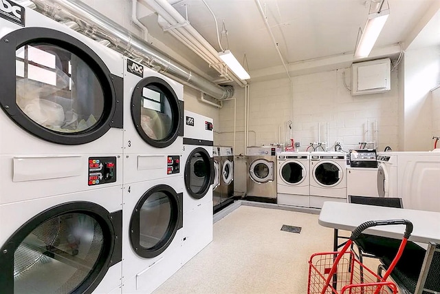 common laundry area featuring washer and dryer, stacked washer / dryer, and light floors