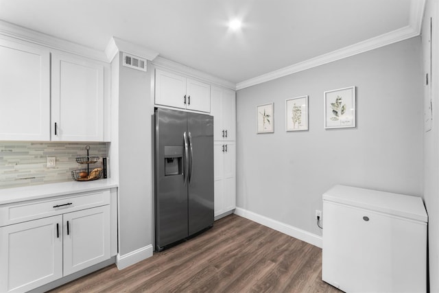 kitchen featuring ornamental molding, decorative backsplash, white cabinets, and stainless steel refrigerator with ice dispenser