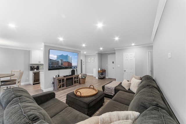 living area with wine cooler, crown molding, and light wood-type flooring