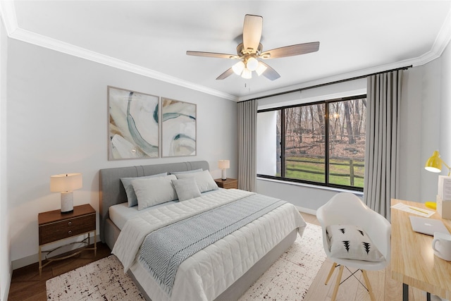 bedroom with crown molding, wood finished floors, baseboards, and ceiling fan