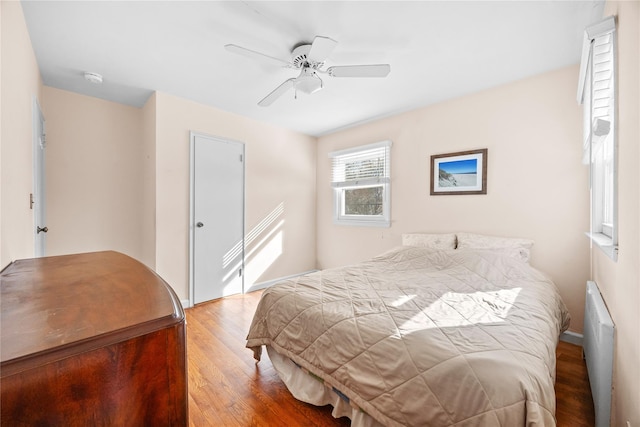 bedroom featuring a ceiling fan and wood finished floors