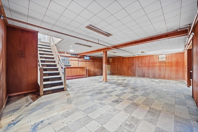 basement with stairway and wood walls