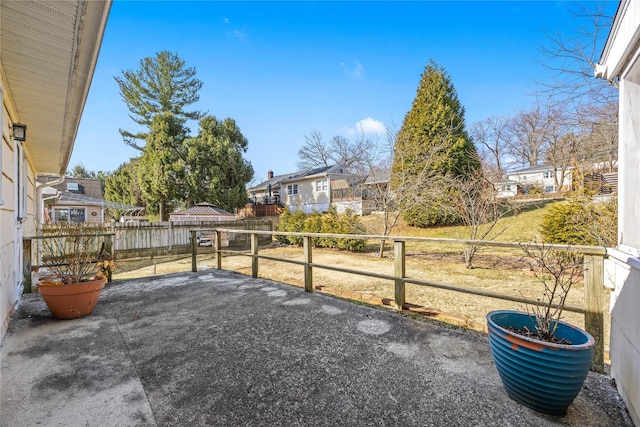 view of yard with a patio area, a residential view, and fence