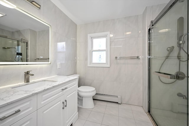 bathroom featuring tile patterned flooring, a baseboard heating unit, vanity, tile walls, and a shower stall