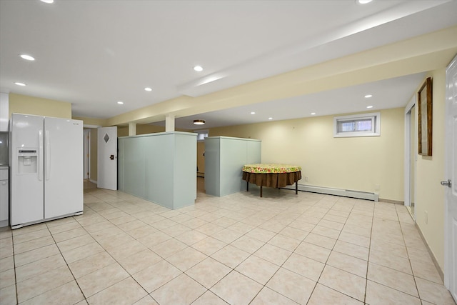 kitchen with a baseboard heating unit, white fridge with ice dispenser, light tile patterned floors, and recessed lighting