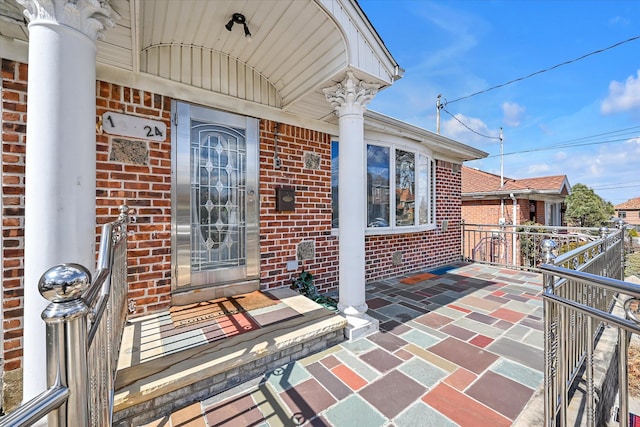 entrance to property featuring brick siding