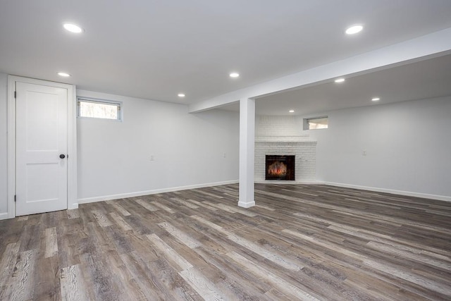 basement featuring recessed lighting, wood finished floors, and baseboards