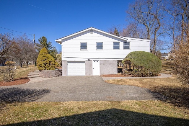 view of home's exterior featuring an attached garage, driveway, and stucco siding