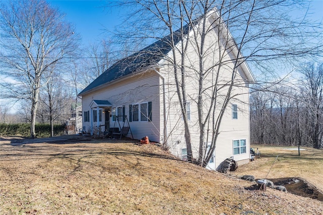 view of side of home featuring a yard