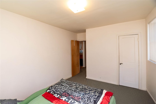 carpeted bedroom with baseboards