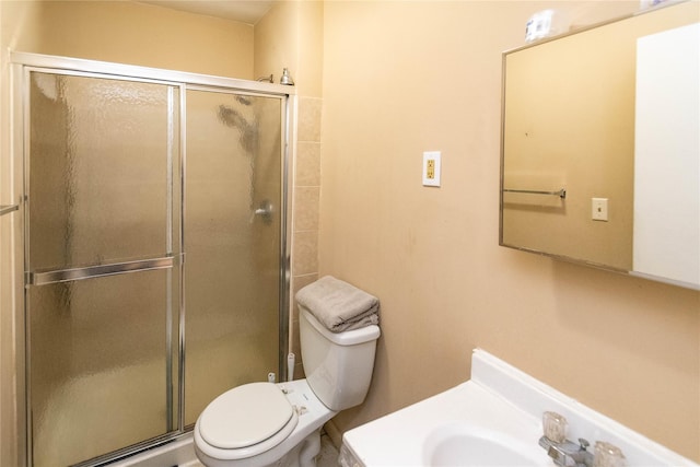 bathroom with toilet, a stall shower, and vanity