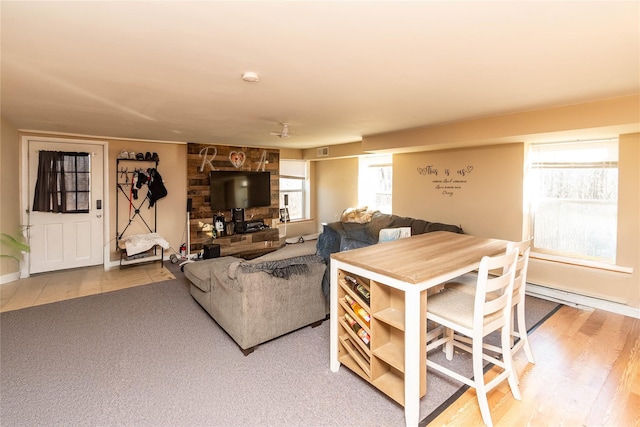 living area with visible vents and wood finished floors