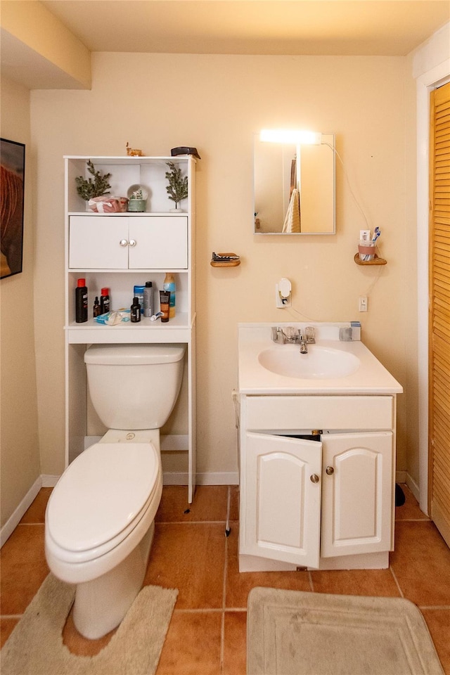 bathroom featuring tile patterned floors, toilet, vanity, and baseboards