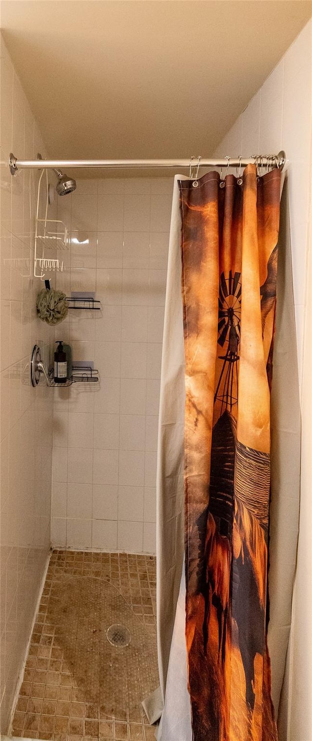 bathroom with a stall shower and vaulted ceiling