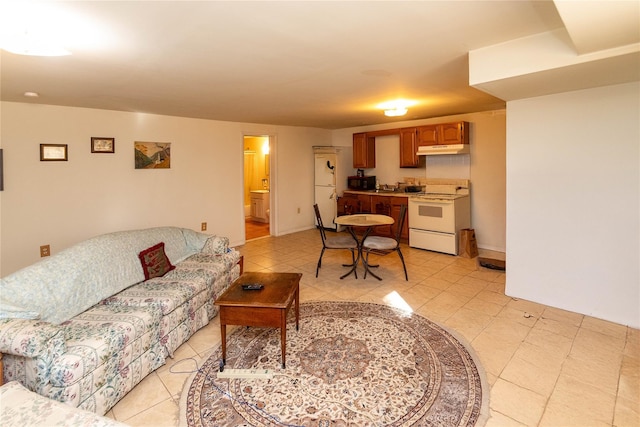 living area featuring light tile patterned floors and baseboards