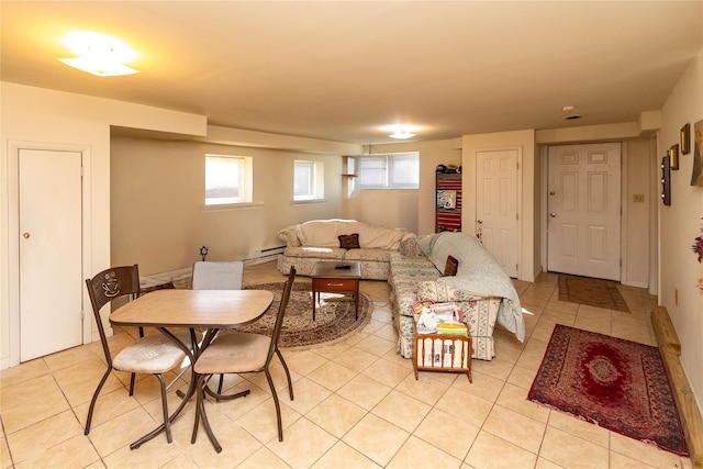 living area with light tile patterned floors and a baseboard heating unit