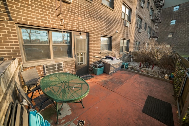 view of patio featuring a grill and fence