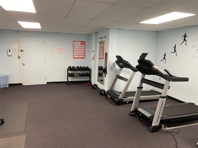 interior space with baseboards and a drop ceiling