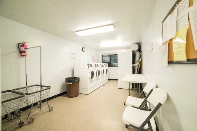 shared laundry area featuring independent washer and dryer, baseboards, and tile patterned floors