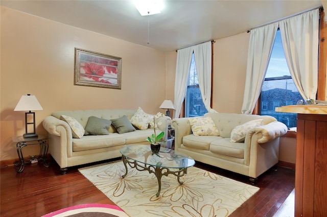 living area with baseboards and hardwood / wood-style flooring