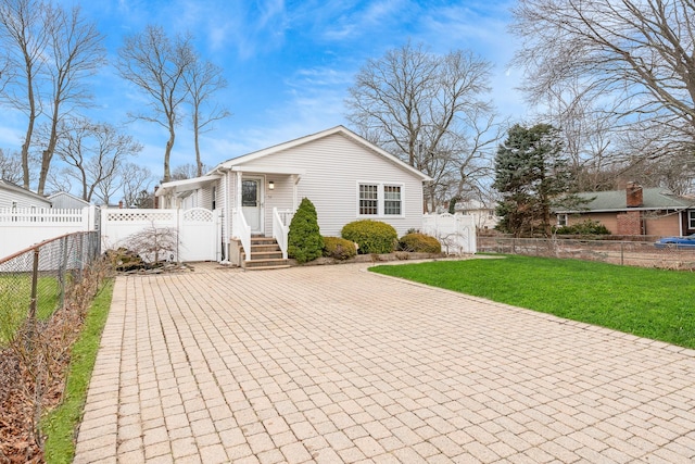 bungalow-style house with a fenced front yard, a front yard, and a gate