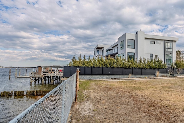 dock area featuring a water view and fence