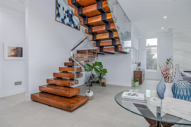 staircase featuring finished concrete flooring, visible vents, crown molding, and recessed lighting