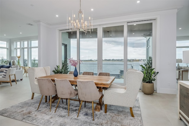 dining room with baseboards, ornamental molding, a water view, an inviting chandelier, and recessed lighting