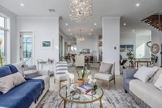 living room with a healthy amount of sunlight, finished concrete floors, visible vents, and a notable chandelier