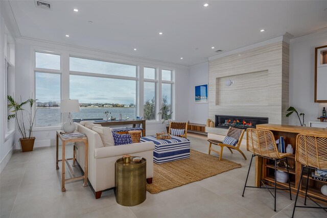 living area with plenty of natural light, ornamental molding, a fireplace, and recessed lighting