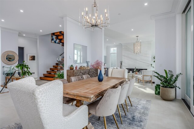 dining area featuring stairs, ornamental molding, recessed lighting, and a notable chandelier