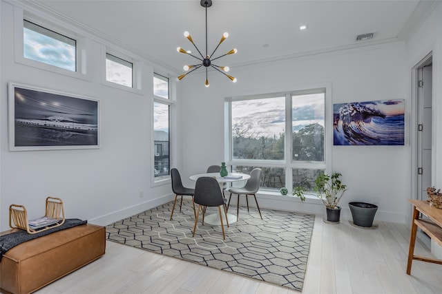 dining area featuring visible vents, wood finished floors, a wealth of natural light, and ornamental molding