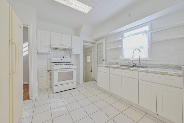 kitchen with open shelves, under cabinet range hood, white appliances, white cabinetry, and a sink