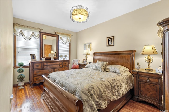 bedroom featuring wood-type flooring and baseboards