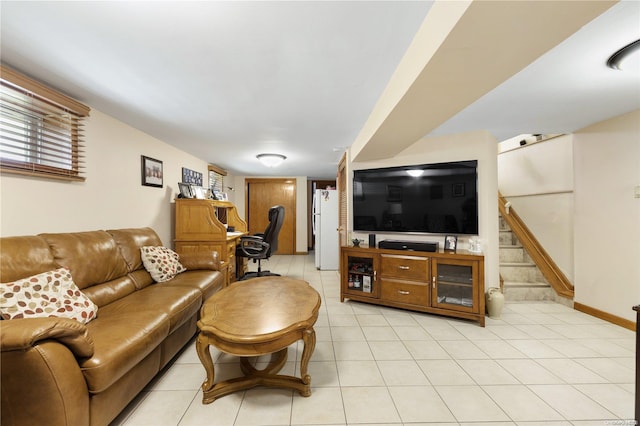 living area featuring light tile patterned floors, baseboards, and stairway