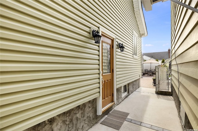 view of property exterior featuring a patio area and fence