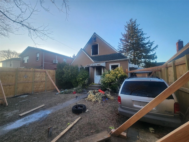 view of front of house with entry steps and fence