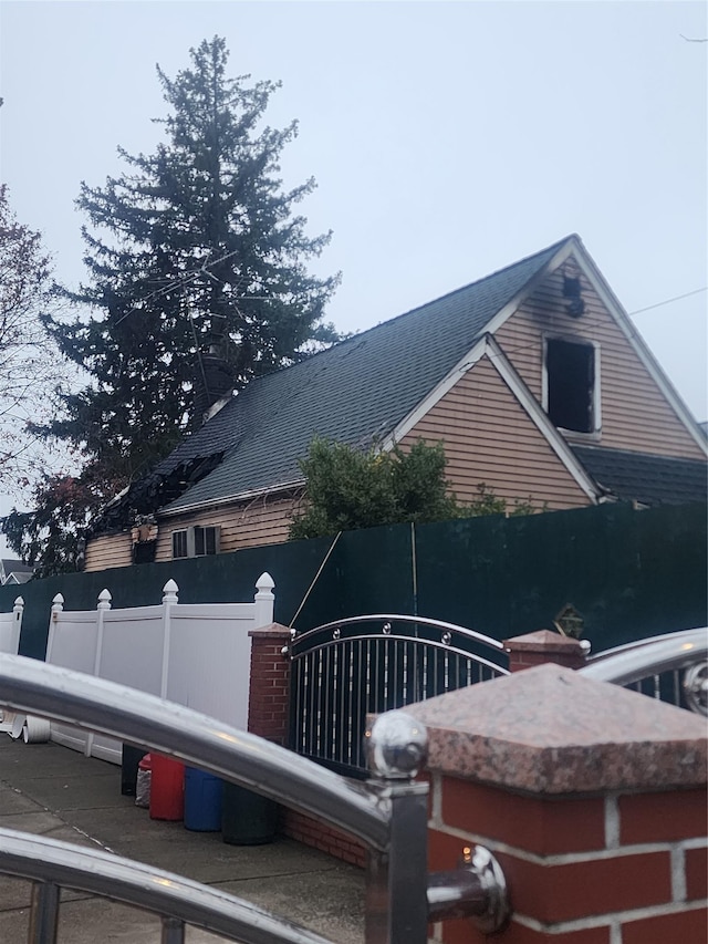 view of side of home featuring fence