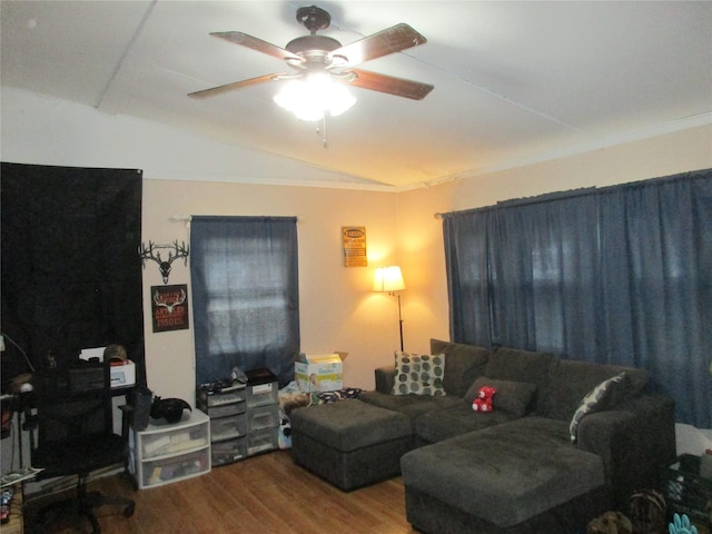 living area with lofted ceiling, ceiling fan, and wood finished floors