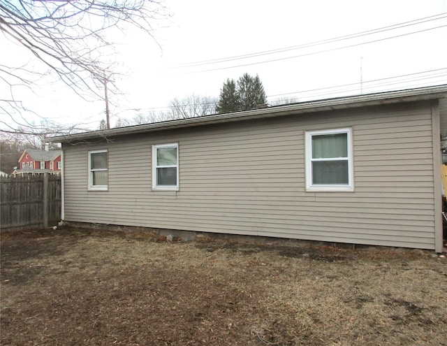 view of side of home with fence