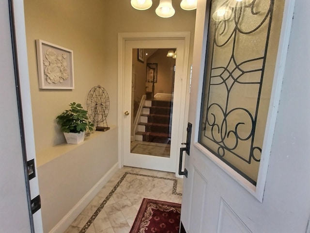 doorway with baseboards and stairs