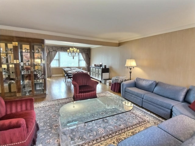 living room with a notable chandelier, crown molding, and wood finished floors