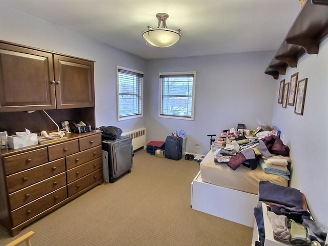 carpeted bedroom with radiator heating unit