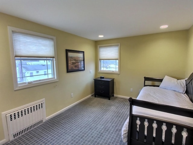 bedroom featuring radiator, carpet, baseboards, and recessed lighting